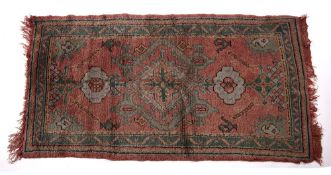 Ushak red ground rug Turkish with central medallion and foliate designs, 170cm x 92cm