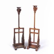 Pair of full height candle stands Chinese with adjustable columns , each on a carved base, .from