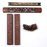 Group of wooden carvings Chinese to include four wood weights and a carved bamboo boat, largest