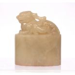 Soapstone seal of oviform Chinese, 19th Century carved with a recumbent Kilin and a cub facing right