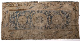 Khotan rug Chinese blue ground with central medallions, 261cm x 126cm