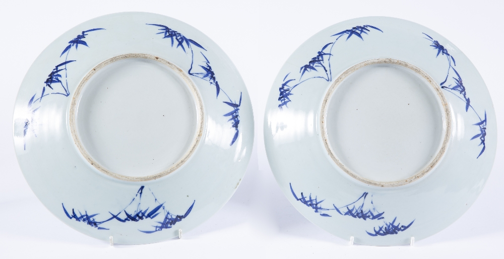 Two blue and white chargers Chinese, 19th Century depicting figures in a garden sat at a table, with - Image 2 of 2