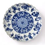 Blue and white dish Chinese, Kangxi period (1662-1722) with a shaped border, the centre decorated