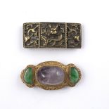 Two belt buckles Chinese the first with gold metal backing with two inlaid jade coloured stones