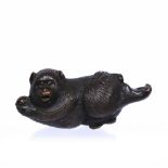 Bronze model of a reclining monkey Japanese, late Meiji (1868-1912) holding a peach and pestered