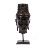 Bronze head of a deity Tibetan, 19th/20th Century on a later metal stand, head 24.5cm, overall