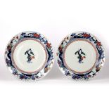 Pair of Kakiemon style large plates Japanese, Edo period each with central blossom and pine within a