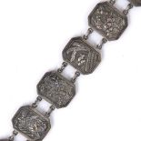 White metal link belt Chinese, circa 1920 with fifteen embossed panels depicting temples, dragons