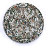 Famille verte circular plaque Chinese, 19th Century having panels of figures and foliate designs,