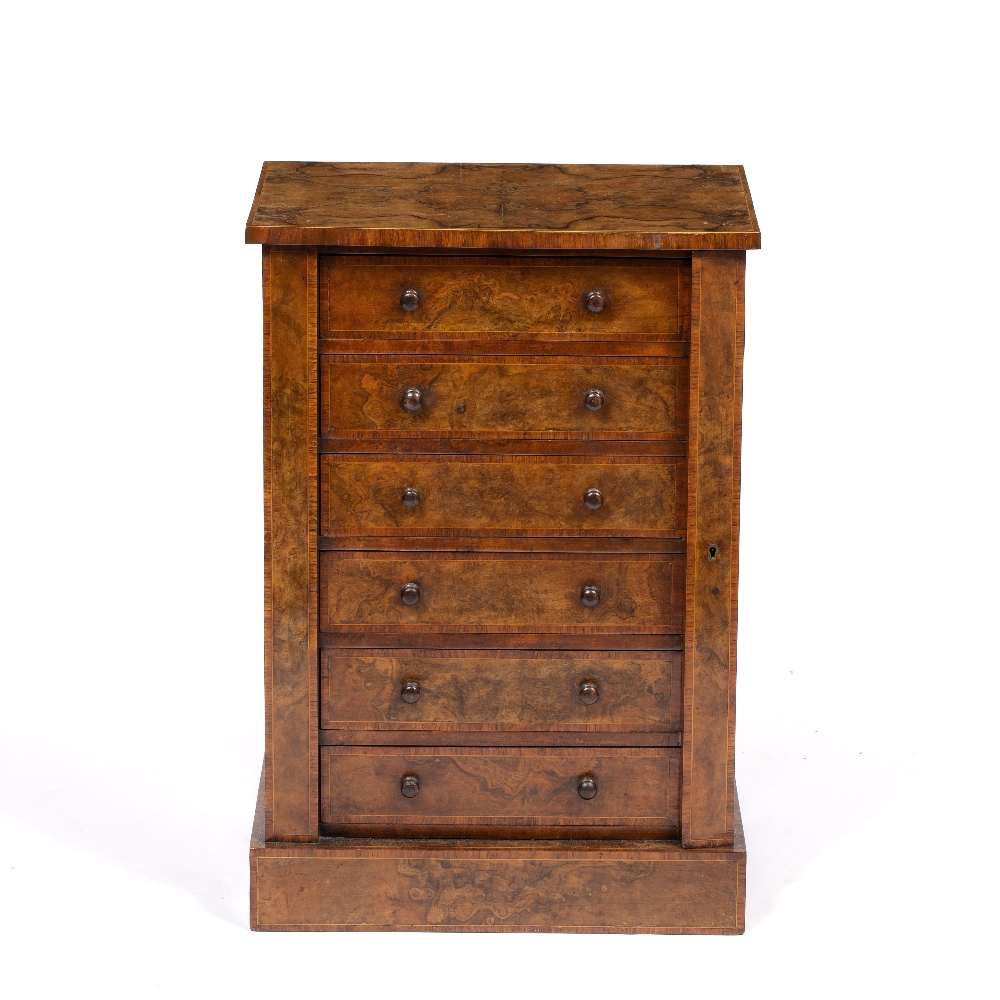 A VICTORIAN FIGURED WALNUT AND ROSEWOOD BANDED COLLECTOR'S CABINET modelled as a Wellington chest,