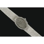A LADY'S DIAMOND SET BRACELET WATCH BY CHOPARD FOR KUTCHINSKY, the oval silvered dial with baton