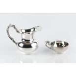 A PERUVIAN SILVER BALUSTER MILK JUG, with scroll handle, 11.5cm high, stamped Sterling 925, 6.5