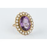 AN AMETHYST AND CULTURED PEARL CLUSTER RING, the oval mixed-cut amethyst claw set within a