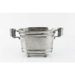 AN AMERICAN PEWTER DOUBLE CHAMPAGNE ICE BUCKET, by Kenneth Turner, of oval form, on disc feet