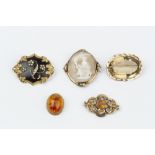 A COLLECTION OF VICTORIAN AND LATER BROOCHES, comprising a black enamel and half pearl memorial