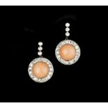 A PAIR OF CORAL AND DIAMOND EAR PENDANTS, each circular cluster drop centred with a coral