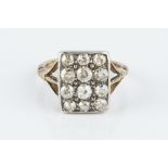 A DIAMOND PANEL RING, the rectangular panel of graduated old-cut diamonds in grain setting,