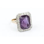AN AMETHYST AND DIAMOND CLUSTER RING, the octagonal mixed-cut amethyst millegrain set within a