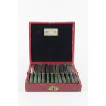 A SET OF TWELVE GEORGE IV SILVER DESSERT KNIVES AND FORKS, with carved green stained bone handles,