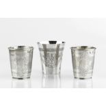A PAIR OF TURKISH SILVER BEAKERS, with engraved decoration, Ottoman Empire marks, 8cm high; and