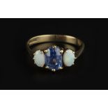 A SAPPHIRE AND OPAL THREE STONE RING, the oval mixed-cut sapphire claw set between two oval cabochon