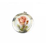 A SILVER AND ENAMEL SMALL HAND MIRROR, the white guilloche enamel ground painted with a spray of