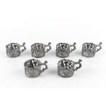 A SET OF SIX LATE VICTORIAN SILVER CUP HOLDERS, pierced and embossed with cherubs and scrolling