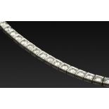 A DIAMOND LINE BRACELET, designed as an articulated line of round brilliant-cut diamonds in square