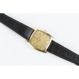 A GENTLEMAN'S 18CT GOLD CASED WRISTWATCH BY JAEGER-LECOULTRE, the cushion-shaped gilt dial with