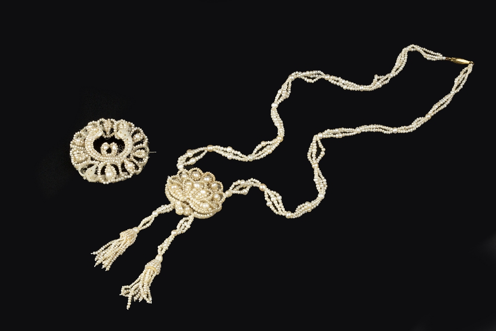 A SEED PEARL PENDANT NECKLACE, the chrysanthemum-shaped panel of graduated seed pearls issuing two