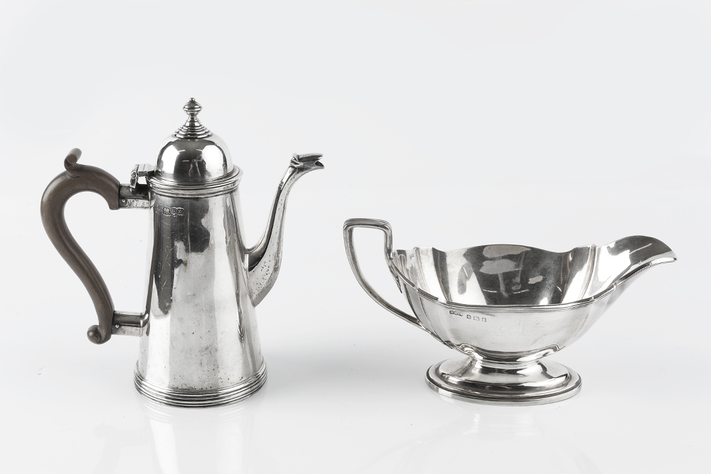 A SILVER SMALL COFFEE POT, of tapering form, with hinged domed cover, and composite handle, by S W