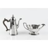 A SILVER SMALL COFFEE POT, of tapering form, with hinged domed cover, and composite handle, by S W