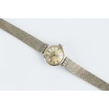 A LADY'S DIAMOND SET BRACELET WATCH BY OMEGA, the circular silvered dial with baton markers, to a