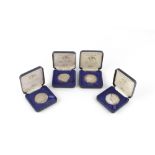 FOUR LIMITED EDITION SILVER PROOF CROWNS, QE2 World Cruise 1979, together with a collection of