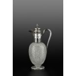 A LATE VICTORIAN SILVER MOUNTED CUT GLASS CLARET JUG, with domed, hinged cover, engraved with