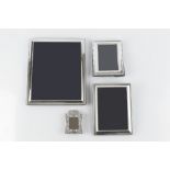 A MODERN SILVER RECTANGULAR LARGE PHOTOGRAPH FRAME, 29cm high overall, two similar smaller frames,