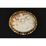 A SHELL CAMEO BROOCH, the oval shell cameo carved to depict a bouquet of flowers and birds, to a