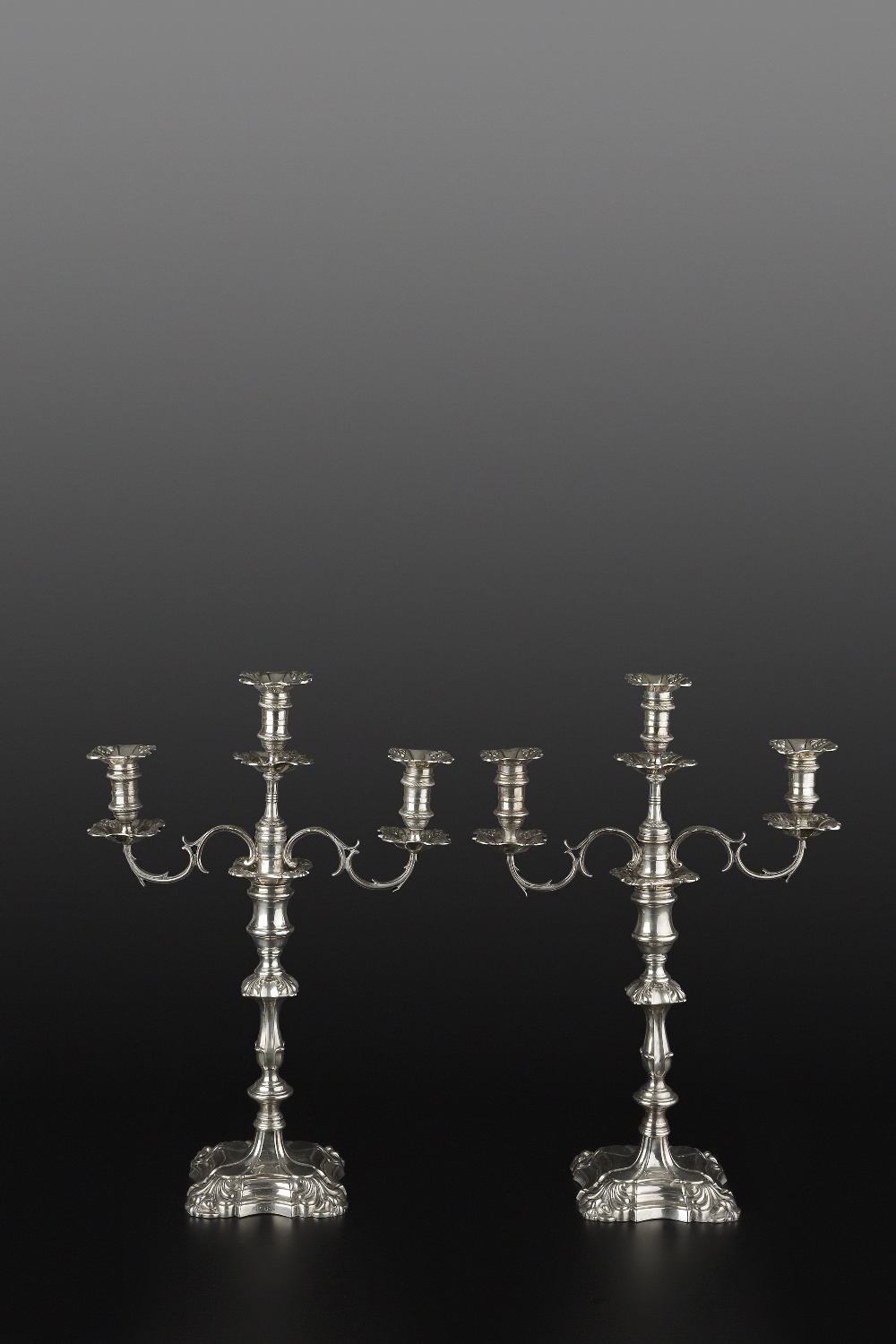 A PAIR OF WILLIAM IV SILVER CANDLESTICKS, with shaped and knopped stems, on shaped square bases,