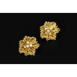 A PAIR OF DIAMOND SET EARRINGS, each designed as an abstract flowerhead, centred with a cluster of