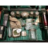 AN EDWARDIAN DRESSING CASE, the fitted interior containing six silver topped faceted glass jars,