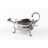 A GEORGE II SILVER SAUCE BOAT, with scroll handle, on shaped pad feet, maker's mark partly