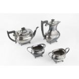 A SILVER FOUR PIECE TEA SERVICE, with beaded borders, the teapot and hot water pot with ebonised
