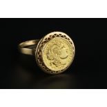 A YELLOW PRECIOUS METAL PANEL RING, depicting the portrait profile of Alexander the Great, with