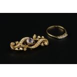 AN AMETHYST AND HALF PEARL PANEL BROOCH, of scrolled openwork design, stamped '15ct', and a