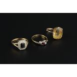 THREE GEM SET DRESS RINGS, comprising a diamond and red stone crossover ring, two colour precious