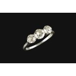 A DIAMOND THREE STONE RING, the graduated round brilliant-cut diamonds in claw setting, white