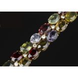 A VARI GEM-SET BRACELET, designed as two rows of vari-coloured oval mixed-cut gemstones and coloured