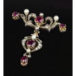 A LATE 19TH/EARLY 20TH CENTURY RUBY, DIAMOND AND PEARL BROOCH, the openwork panel of foliate