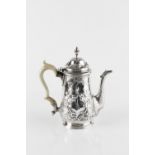 AN 18TH CENTURY SILVER COFFEE POT, with hinged domed cover, embossed with flowers and scroll work,