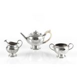 A MID VICTORIAN SILVER THREE PIECE BACHELOR'S TEA SERVICE, with beaded borders and engraved with